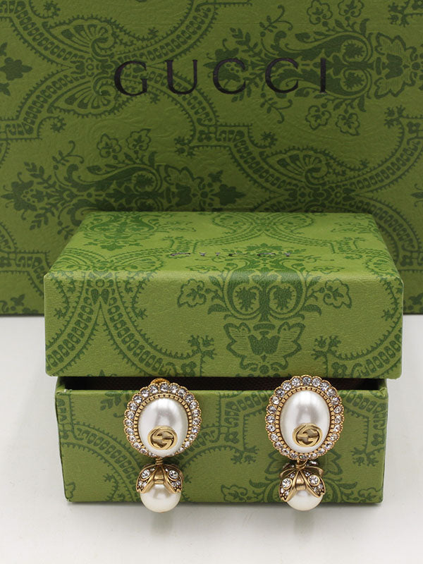 حلق قوتشي بيضاوي انتيك لوقو حلق gucci برونزي