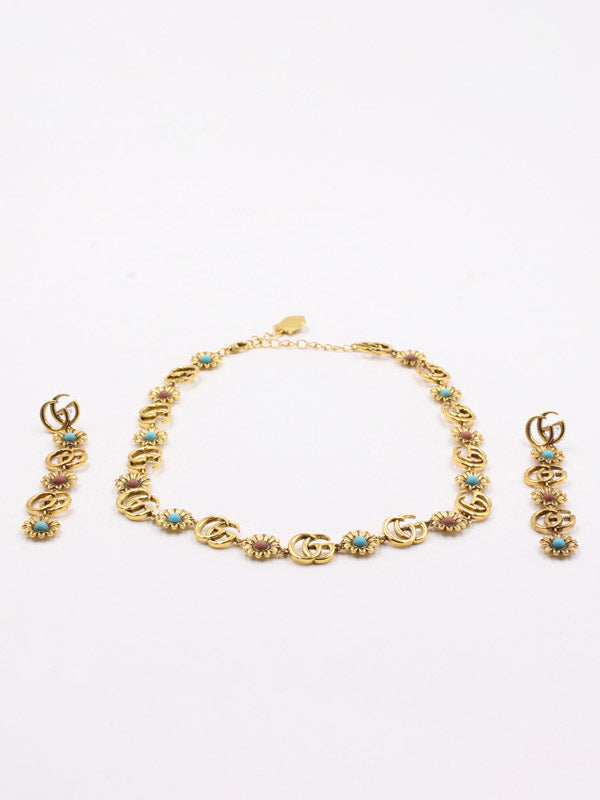 طقم قوتشي احجار ملونه ذهبي اطقم gucci