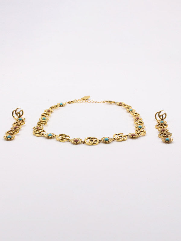 طقم قوتشي احجار ملونه ذهبي اطقم gucci