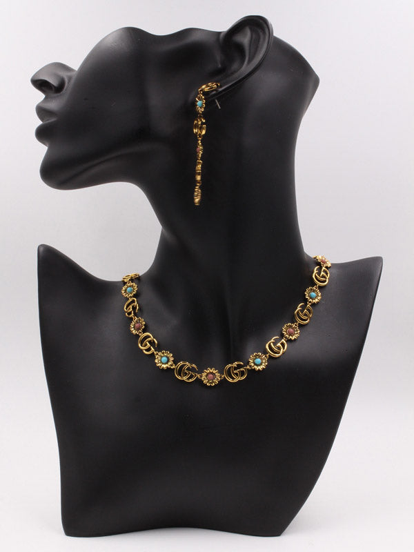 طقم قوتشي احجار ملونه ذهبي اطقم gucci