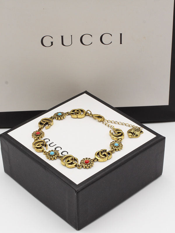 اسواره قوتشي احجار ملونه شعار اسواره gucci ذهبي 